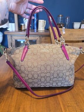 Coach Kelsey Satchel with Outline Signature canvas and magenta pink accents.